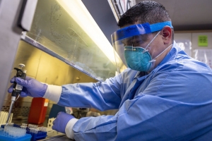 A Sailor takes a test sample in the laboratory aboard USNS Mercy (T-AH 19).